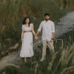 Walking hand-in-hand down a country path. This image captures the feeling of a shared journey, perfect for an outdoor pre-wedding photoshoot.
