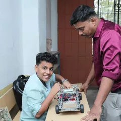 An instructor provides one-on-one guidance to a student working on his robot. This personal attention is a cornerstone of our teaching method, ensuring every child understands the concepts and feels supported.