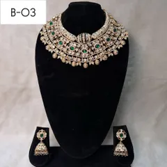 This is my white meenakari bridal choker, B-03. The intricate green and white enamel work gives it a unique and sophisticated look, paired with classic jhumkas.