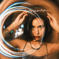A creative portrait where the model is adjusting a snake-like headband. I used a special filter to create a circular light trail effect, giving the image a magical and dynamic quality.