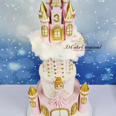 For a little princess's third birthday, I designed this magnificent four-tier castle cake. Complete with golden turrets, delicate sugar-spun clouds, and a beautiful princess figurine, it's a fairytale brought to life in pastel pink and gold.