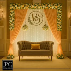 An engagement marks a beautiful new chapter. I designed this elegant backdrop with soft peach drapes, a custom 'V&S' monogram, and warm fairy lights to create a romantic and personal atmosphere for the ring ceremony.