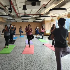 For teams with dedicated space, I offer on-site mat yoga classes like this one at Johnson & Johnson. We work on balance and focus with poses like Vrikshasana (Tree Pose), building both individual stability and collective calm.