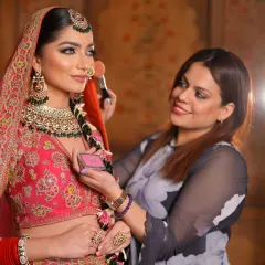 Here I am applying a soft blush to the bride's cheeks. This step adds a healthy, natural-looking flush of color to her complexion.