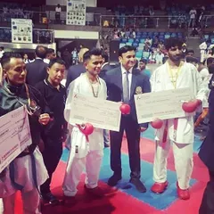 Success in competitive karate also brings professional recognition. Here are my senior fighters receiving their winner's checks at a national level tournament, a testament to their skill and dedication.