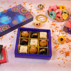 Getting into the festive spirit with my Diwali hampers. ✨ This shot shows some of my bestselling eggless treats, like assorted chocolates and sweets, all packed in these beautiful, vibrant boxes. Perfect for gifting to family, friends, or colleagues.