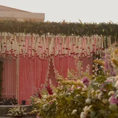 A closer look at the floral details of the mandap. We used a mix of white, pink, and deep magenta flowers to create a rich, textured look along the aisle, leading to the beautifully draped stage.