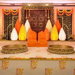 A traditional Haldi or Mehendi stage setup. I used a backdrop of marigold garlands, a rustic carved wooden door, and large urlis for a classic and auspicious feel.