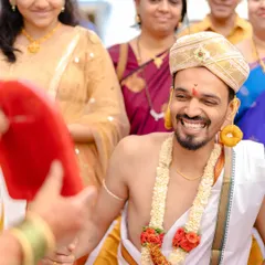 Wedding traditions are often filled with so much fun and laughter. The groom's genuine smile during this ritual is a perfect example of the candid, happy moments I love to photograph.