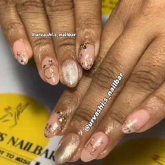 A delicate and dreamy manicure featuring a soft pink base with gold accents. I added personalized initials, a tiny ring charm, and a sprinkle of glitter for a charming and romantic feel.