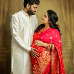 The love in your eyes says it all. This couple's portrait in traditional attire is a beautiful celebration of your journey to parenthood, blending culture with the excitement of what's to come.