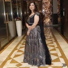 A happy client looking absolutely breathtaking in a custom-made navy blue and silver geometric pattern lehenga. This is a perfect example of a modern, premium design for a reception or cocktail event.