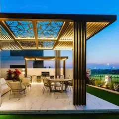 A showcase of luxury outdoor living, this rooftop pergola features custom CNC-cut panels with a leaf motif, integrated lighting, and slatted side panels. We designed it to be a complete outdoor room for evening entertainment, combining functionality with high-end aesthetics.