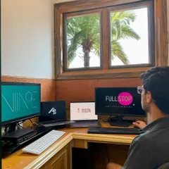 A look at my other side: entrepreneur by day, DJ by night. This is my workstation where I manage my businesses, with logos for Niine Artist and Full Stop Entertainment on the screens.