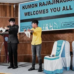 Two boys on stage, completely focused on learning a magic trick with me. I enjoy teaching simple illusions to my volunteers, making them part of the secret.