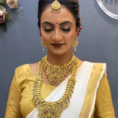 A close-up of our South Indian bridal look, focusing on the golden eye makeup and bold lip that complements the temple jewellery.