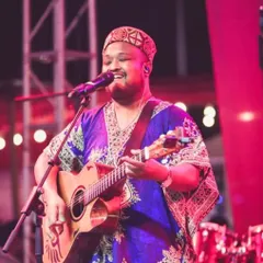 Expressing through music is a good addiction. A happy moment on stage, smiling while playing and singing for the crowd.