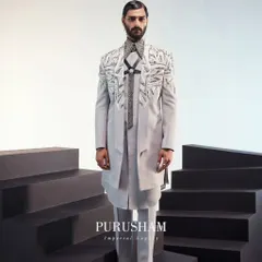 A full-length view of the grey fusion outfit. The asymmetrical cut and unique textures are designed to create a fresh, powerful silhouette that stands apart from traditional menswear.