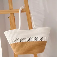 Here is the stylish rope tote bag hanging on a wooden stand, showing how it can also be a beautiful decor accessory in your home when not in use. Its neutral colors match any outfit or room.