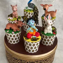 These little cuties won "Best In Show" at the India Bake Show! This set of decorated cupcakes tells the story of Krishna in the forest, surrounded by his animal friends. Each topper is a tiny, handmade sculpture.