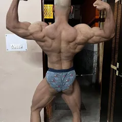 The rear double bicep pose is essential for showing back width and thickness. This image shows the level of detail and conditioning my programs aim to achieve, from the traps down to the glutes and hamstrings.