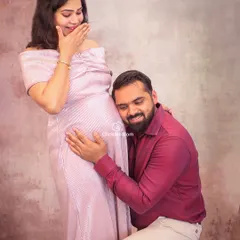 Listening for the first flutters and kicks. This is such a sweet and interactive moment between parents-to-be, full of wonder and connection. It’s a candid and heartwarming pose that tells a beautiful story.