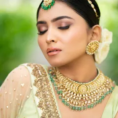 A close-up beauty shot focusing on the flawless makeup and intricate jewelry. This type of shot is perfect for makeup artists' portfolios or jewelry brands.