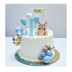 A classic first birthday cake with a fresh fruits flavor. This design features a sweet teddy bear, balloon decorations, and a simple, elegant finish.