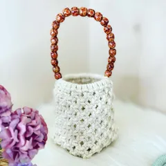 My macrame potli bag is a perfect accessory for festive occasions. This one is made with a natural cream cord and features a handle made of beautiful amber-colored beads.