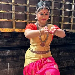 A close-up from our dance tour in Kerala, dressed in a vibrant pink and gold costume. Performing in different cities allows us to share our art with new audiences and experience the local culture.