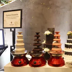 Opulent Desserts. A trio of chocolate fountains, in dark, white, and ruby chocolate, offers an interactive and indulgent experience for guests.