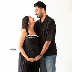 The look of love. This candid moment between the couple is so sweet. The simple white background keeps the focus entirely on their happy expressions and connection.