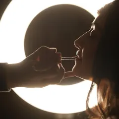 The magic begins. A silhouette shot of me applying lipstick, with the ring light creating a beautiful halo effect. This is where the final look comes together.
