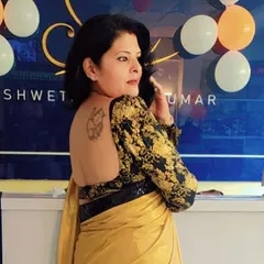 This backless design features full-length sleeves in a black and gold brocade, paired with a simple yellow saree for a striking contrast.