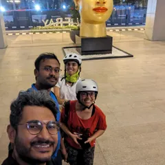 A fun group selfie in front of a sculpture at RMZ Ecoworld. A planned ride to Indiranagar turned into an unexpected adventure to Bellandur, filled with laughter and exploration.