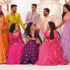 A happy, candid group photo of the couple with their friends, all sharing a laugh. This is what a celebration with your favorite people looks like.