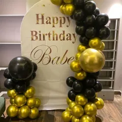 A chic and modern "Happy Birthday Babe" setup. The black and gold balloon arch frames a custom arched backdrop, creating a perfect, stylish photo corner for an adult birthday party.