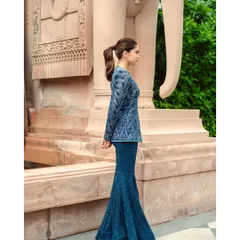 A full-length fashion portrait of Sharvari, showcasing the stunning silhouette of this Ritika Mirchandani creation. The architectural background adds a sense of grandeur to this elegant celebrity look.