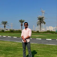 A full-length shot of the grey bootcut jeans in a park setting, highlighting their flattering silhouette and perfect length.