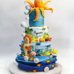 I created this grand underwater-themed cake for a truly memorable celebration. Every element, from the towering octopus and seahorse to the tiniest shells and fish, was hand-molded, making it a fully edible aquatic wonderland.