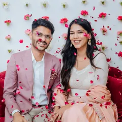 A couple showered in petals at their home Roka ceremony, a moment of pure, unscripted happiness.