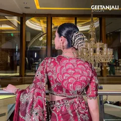 A detailed shot of the intricate hair accessory and the clean lines of the bun, a perfect example of traditional elegance.
