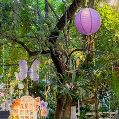 A personalized photo display for a first birthday party. The butterfly and floral theme is carried through in the decor, creating a sweet and memorable corner to showcase precious memories.