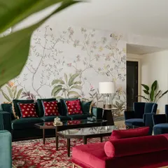 This angle shows how the sprawling floral mural wraps around the room, creating an immersive garden-like experience that is both elegant and timeless.
