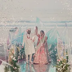 For this destination wedding, I created a modern, ethereal mandap right on the beach. The iridescent panels caught the light beautifully, and the surrounding sparklers made the couple's special moment feel like a scene from a movie.