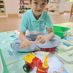 A young student carefully assembling his project. My classes for this age group focus on developing fine motor skills and concentration in a playful, nurturing environment.