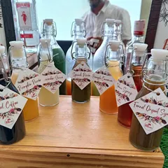 My collection of house-made syrups. I create unique flavors like Spiced Coffee, Pumpkin Purée, and Fennel Orgeat, all presented in labeled bottles for crafting truly bespoke and artisanal cocktails.