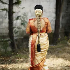 A perfect example of a classic South Indian bridal braid, adorned with a traditional gold jadanagam and fresh white flowers (mallige hoovu).