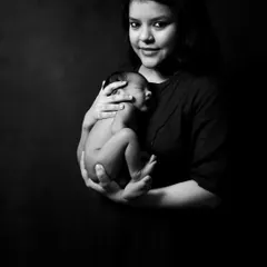 A beautiful and intimate portrait of a mother cradling her sleeping baby. These quiet, simple moments are what make newborn photography so incredibly special.