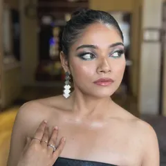 This side profile shows the beautiful shape and blending of the smokey eye. The skin is kept luminous and glowing to contrast with the matte, dark eyeshadow.